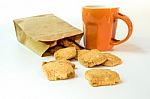Cookies In Paper Bag And A Cup Of Coffee Stock Photo