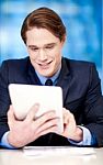 Corporate Guy Browsing On Tablet Pc Stock Photo