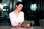 Corporate Lady Operating Her Tablet Device Stock Photo
