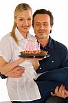 Couple Celebrating Birthday With Cake Stock Photo