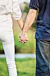 Couple Holding Hands In Park Stock Photo