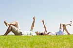 Couple Lie Down On Grass Stock Photo