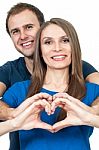 Couple Making Heart Gesture Of Love Stock Photo