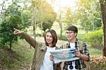 Couple Of Tourists Heading To The Forest With Maps In Hand Searc Stock Photo