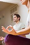 Couple Sitting On Floor Doing Yoga Stock Photo