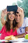 Couple Taking Photo Of Themselves With Smart Phone On Romantic P Stock Photo