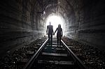 Couple Walking Together Through A Railway Tunnel Stock Photo