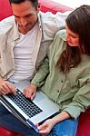 Couple With Laptop And Credit Card Buying Online Stock Photo