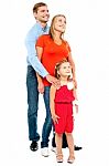 Couple With Their Girl Child Looking Upwards Stock Photo