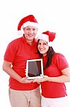 Couple With Touchpad On Christmas Stock Photo