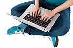 Cropped Image Of A Girl Working On Laptop Stock Photo