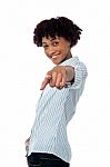 Curly Haired Casual Woman Pointing Towards You Stock Photo