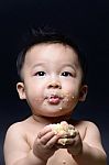 Cute Asian Baby Boy Eating Cake With His Both Hand And Messy On Stock Photo