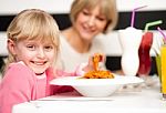 Cute Kid Enjoying Pasta And Juice Stock Photo