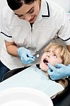 Cute Kid Examined By Dental Assitant Stock Photo