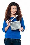 Cute Woman In Blue Attire Holding Clapperboard Stock Photo