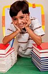 Cute Young Boy Resting On Books Stock Photo