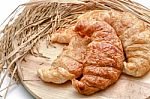Delicious Fresh Croissants With Rice On Wooden Background Stock Photo