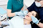 Dentist Cleaning A Patient Teeth Stock Photo