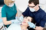 Dentist Cleaning A Woman Teeth Stock Photo