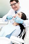 Dentist Examine On A Female Patient Stock Photo
