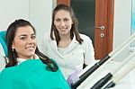 Dentist Examining A Patient's Teeth In The Dentist Stock Photo