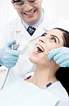 Dentist Treating His Patient Stock Photo
