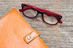 Diary Booklet And Eye Glasses On Wooden Desk Stock Photo