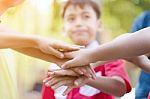Diverse Children With Joined Hands As A Team Outdoor Stock Photo