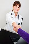 Doctor And Patient Shaking Hands Stock Photo