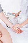 Doctor Gets Measure The Pressure To Woman Patient Stock Photo
