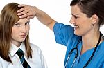 Doctor Placing Her Hand On A Patients Forehead Stock Photo