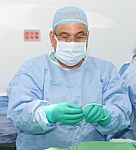 Doctor Preparing A Catheter For Insertion On A Patient. Slide Sa Stock Photo