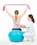 Doctor With Medical Ball And Woman Patient Stock Photo