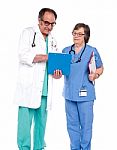 Doctors Discussing Medical Report Stock Photo