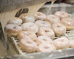 Donuts Being Glazed Stock Photo