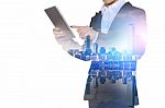 Double Exposure Of Businessman Holding Tablet With Cityscape Blurred Background, Business Concept Stock Photo