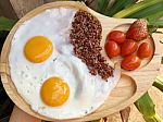 Double Fried Eggs With Brown Quinea Stock Photo