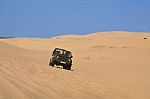 Driven Jeep Car On Desert Stock Photo