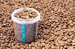 Dry Brown Pet Food (dog Or Cat) With Measure Glass Stock Photo