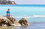 Dutch Teenage Boy Fishing With Rod Near Sea And Beach Stock Photo