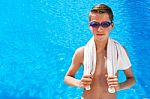 Dutch Teenage Boy Wearing Swimming Goggles And Towel At Swimming Stock Photo