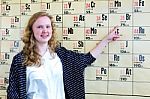 Dutch Teenage Girl Pointing Finger At Periodic Table Stock Photo