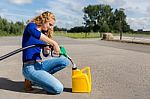 Dutch Woman Fueling Jerrycan With Petrol Hose Stock Photo