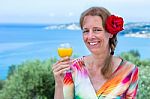 Dutch Woman With Drink And Red Rose Near Sea Stock Photo