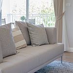 Earth Tone Color Sofa With Pillows In Modern Living Room Stock Photo