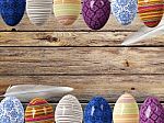 Easter Eggs And Bird Feathers On Wood Background With Space Stock Photo