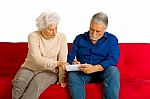 Elderly Couple Writing Stock Photo