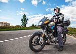 Elderly Motorcyclist Wearing A Jacket And Glasses With A Helmet Stock Photo