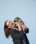 Woman Laughing Happy With Puppy Stock Photo